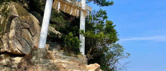 A stone arch on a rocky hill.