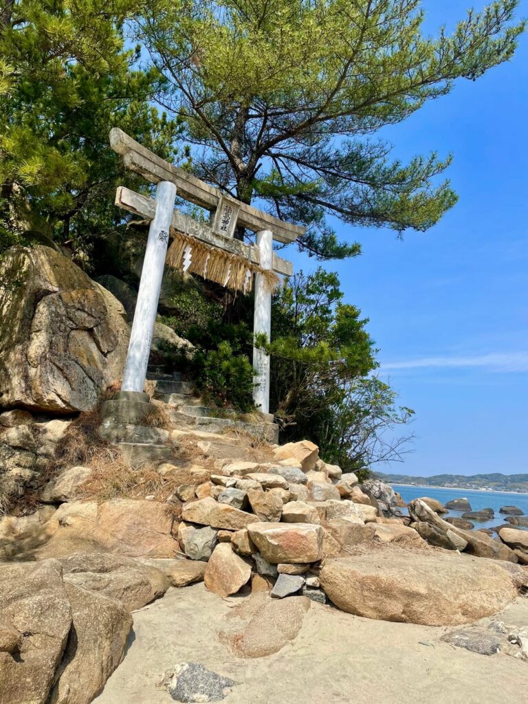 A stone arch on a rocky hill.